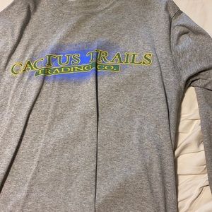 Travis Scott Trading Co. long sleeve shirt.